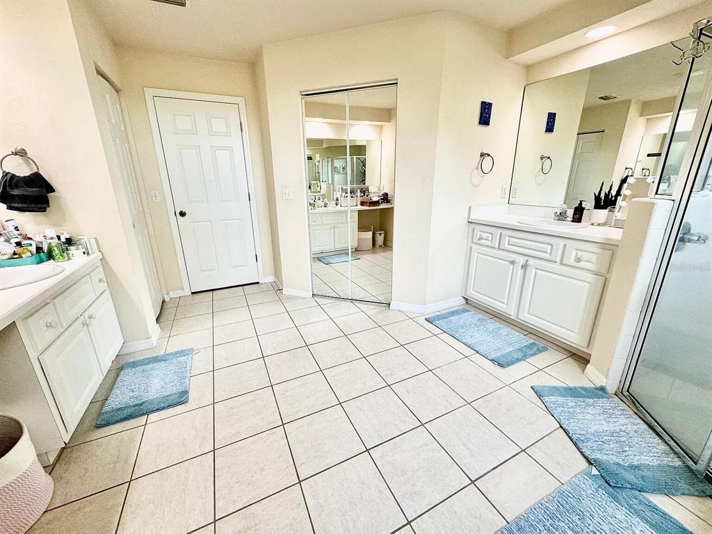 5164 Southwest 82 Terrace Gainesville, FL 32608 - Photo 7 of 25 a bathroom with a sink a mirror and a shower