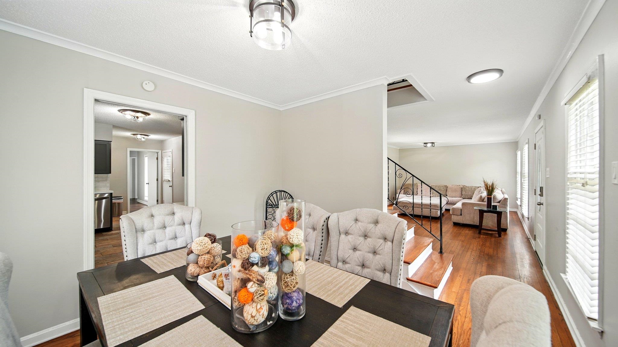 359 South Fenwick Road Memphis, TN 38111 - Photo 10 of 31 Dining area featuring crown molding, hardwood / wood-style floors, and a textured ceiling