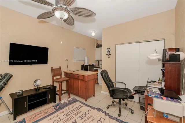 a view of a workspace with furniture and a flat screen tv