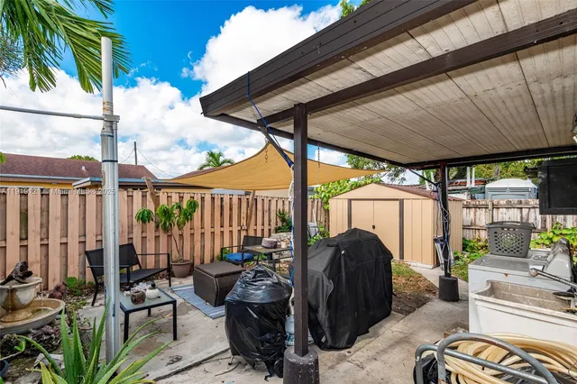 a view of a chairs and table in backyard