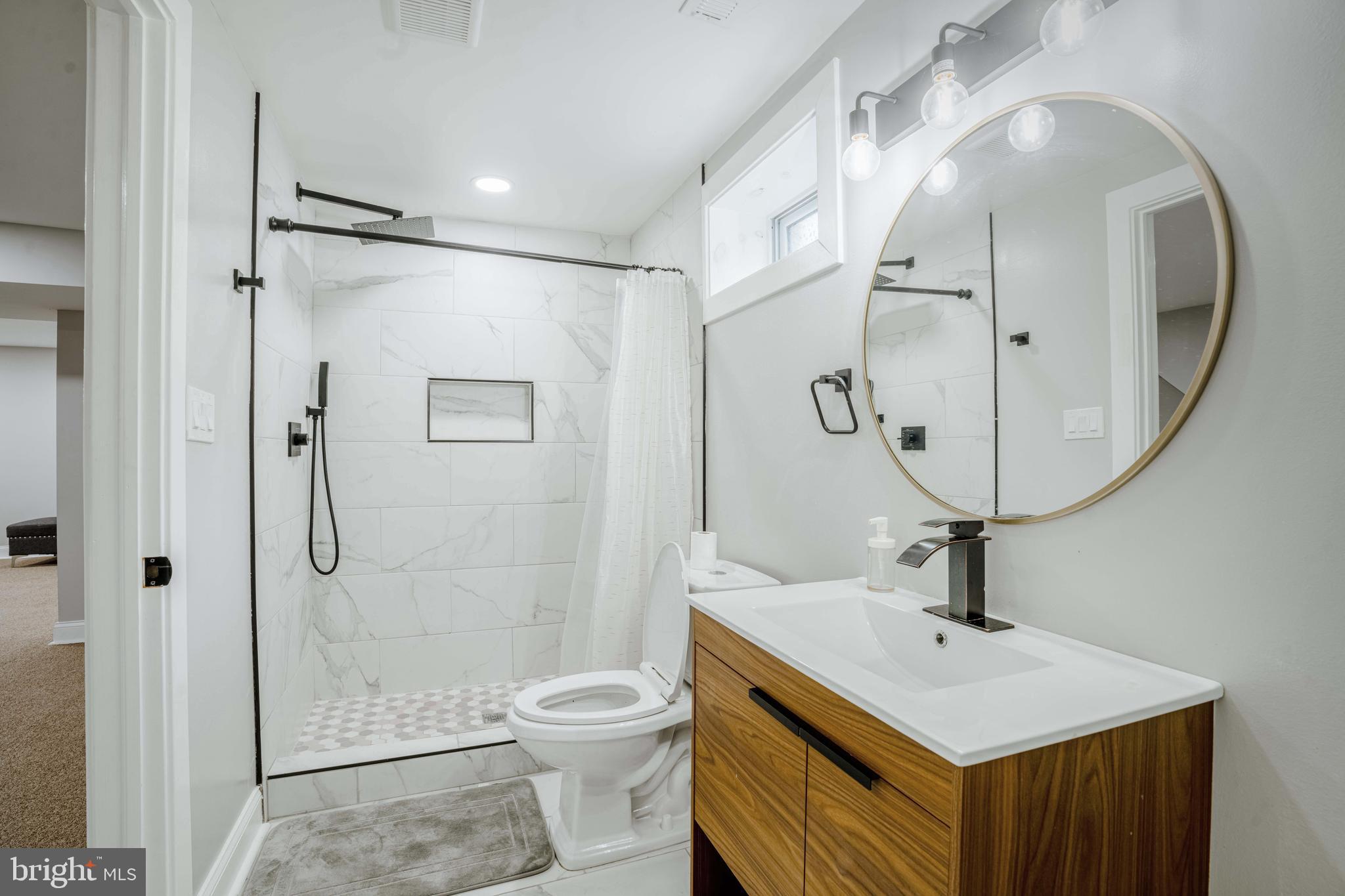 923 Ray Road Hyattsville, MD 20783 - Photo 29 of 32 a bathroom with a sink a toilet and shower