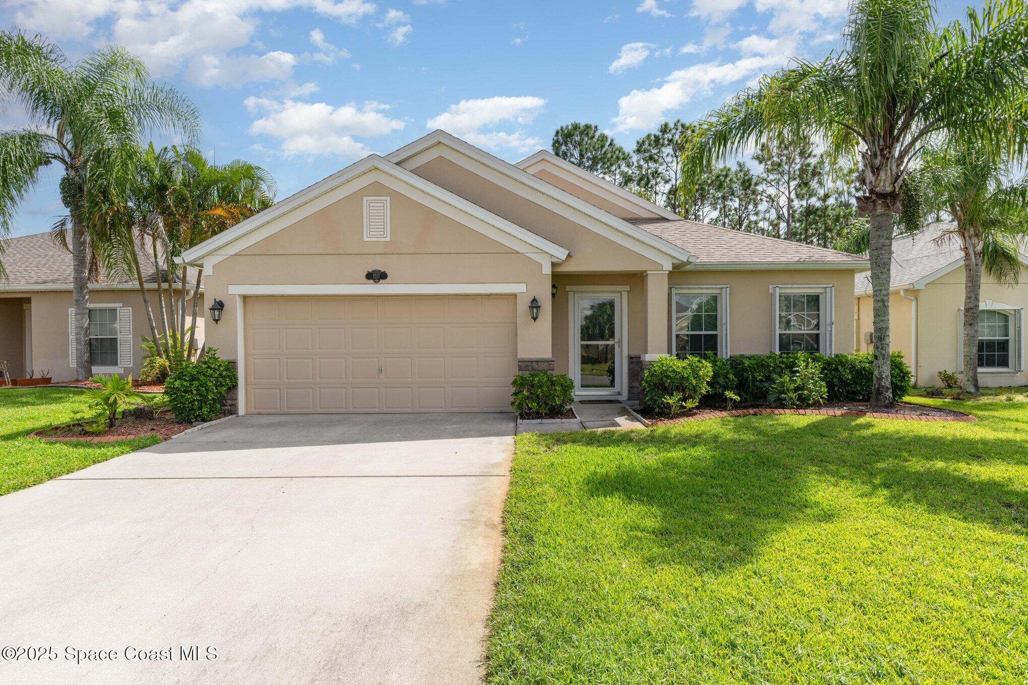 a front view of house with yard and green space