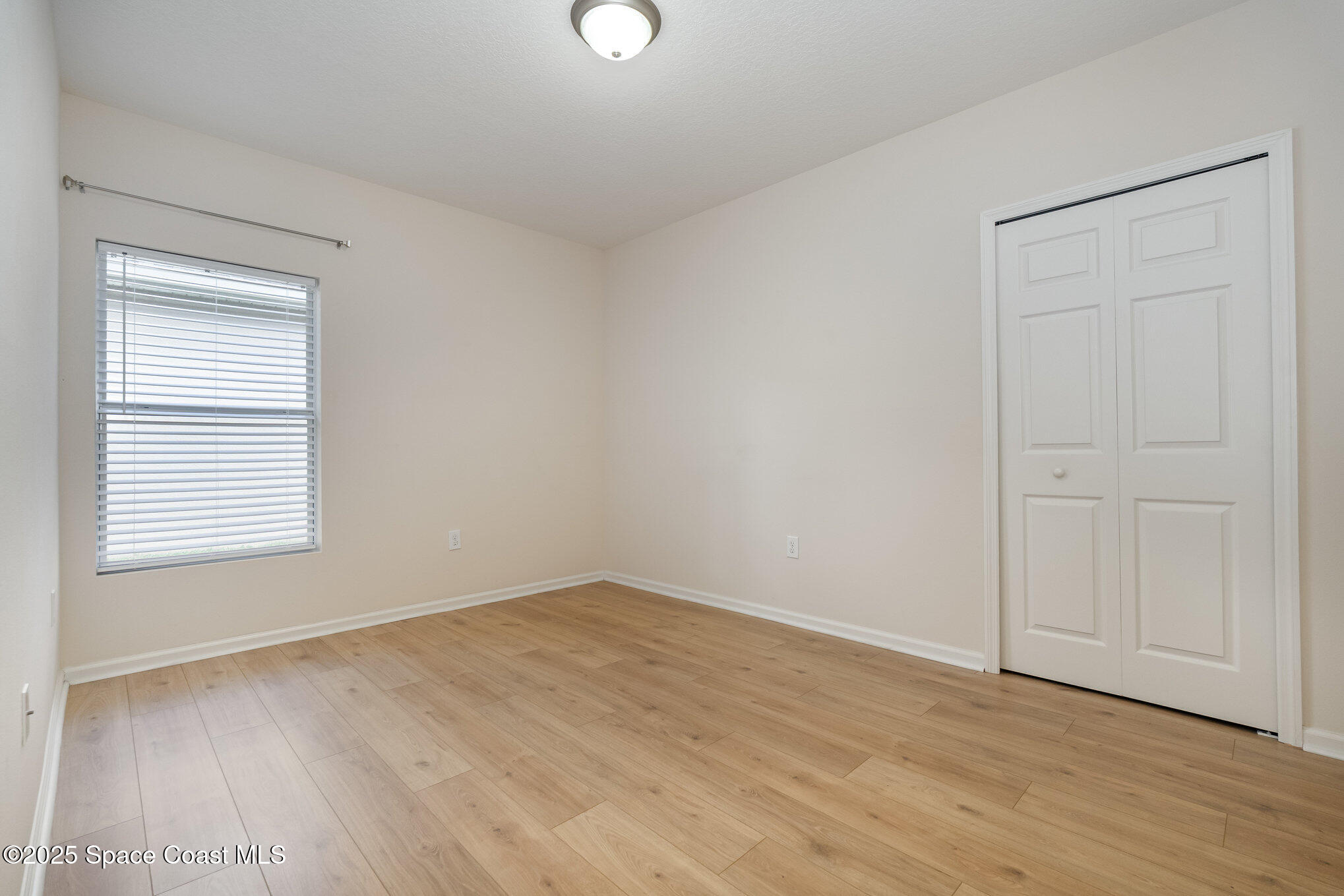1517 Attilburgh Boulevard Melbourne, FL 32904 - Photo 12 of 15 a view of an empty room with wooden floor and a window