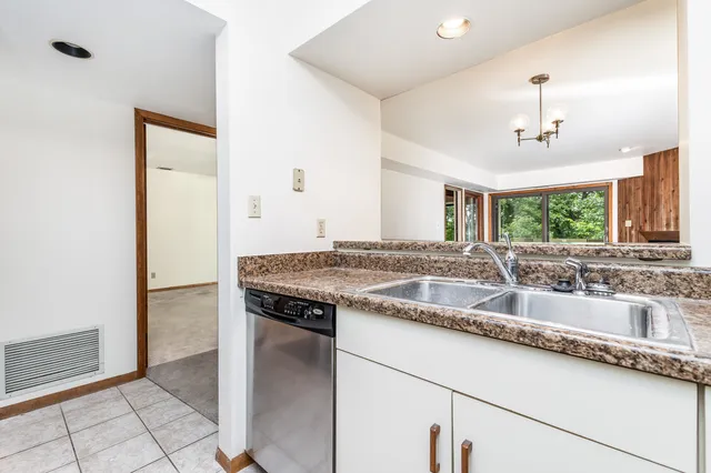 a kitchen with granite countertop a sink and a stove
