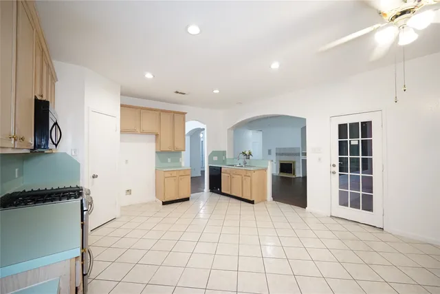 a kitchen with stainless steel appliances a refrigerator sink and cabinets