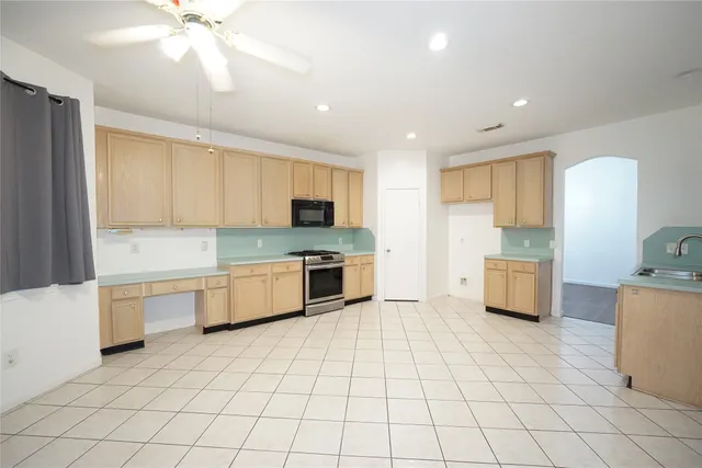 a kitchen with stainless steel appliances a stove sink and cabinets