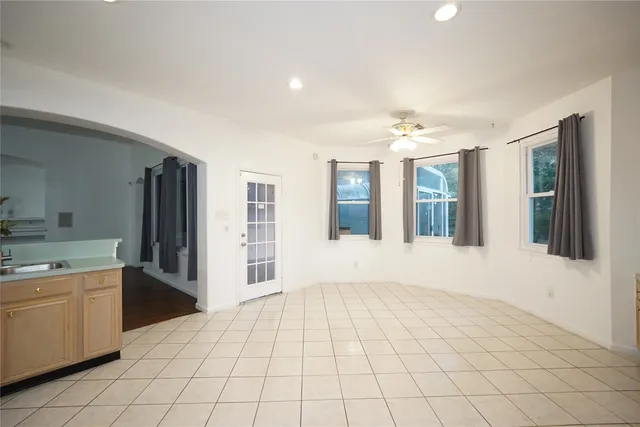 a view of a kitchen with windows and furniture