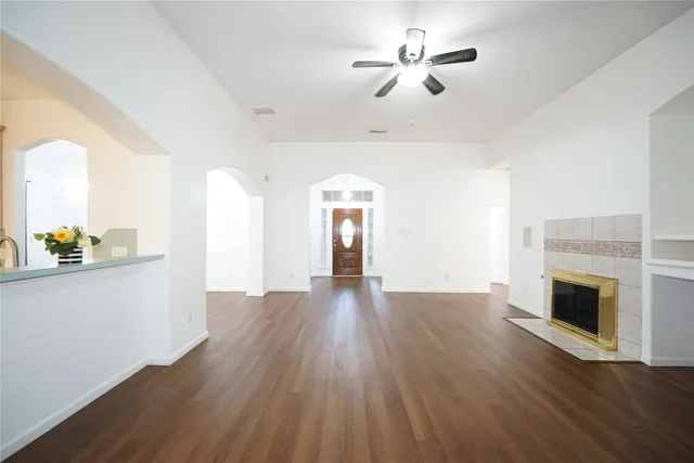a view of empty room with wooden floor and fireplace