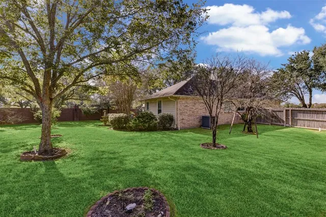 a view of a house with a backyard