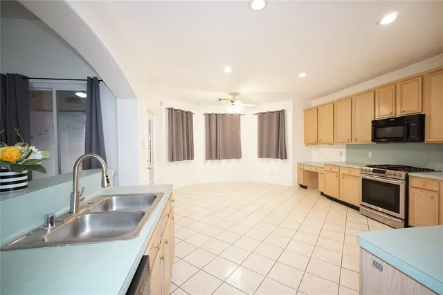 a kitchen with stainless steel appliances granite countertop a sink and a stove