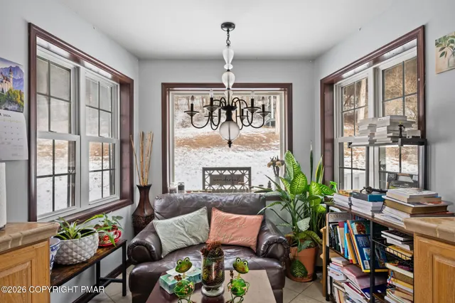 a living room with furniture a fireplace and windows