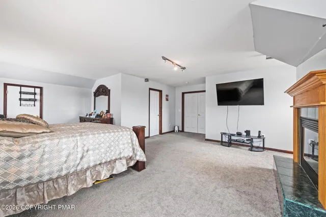 a bedroom with bed and tv