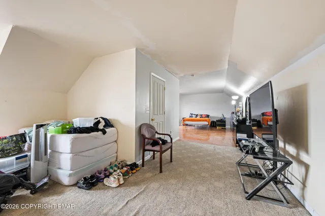 a living room with furniture and gym equipment