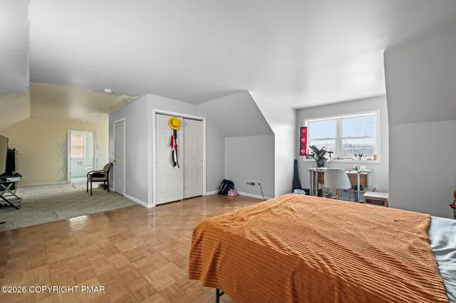 a bed room with a bed and a chair