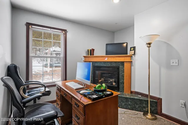 a living room with furniture a fireplace and a window