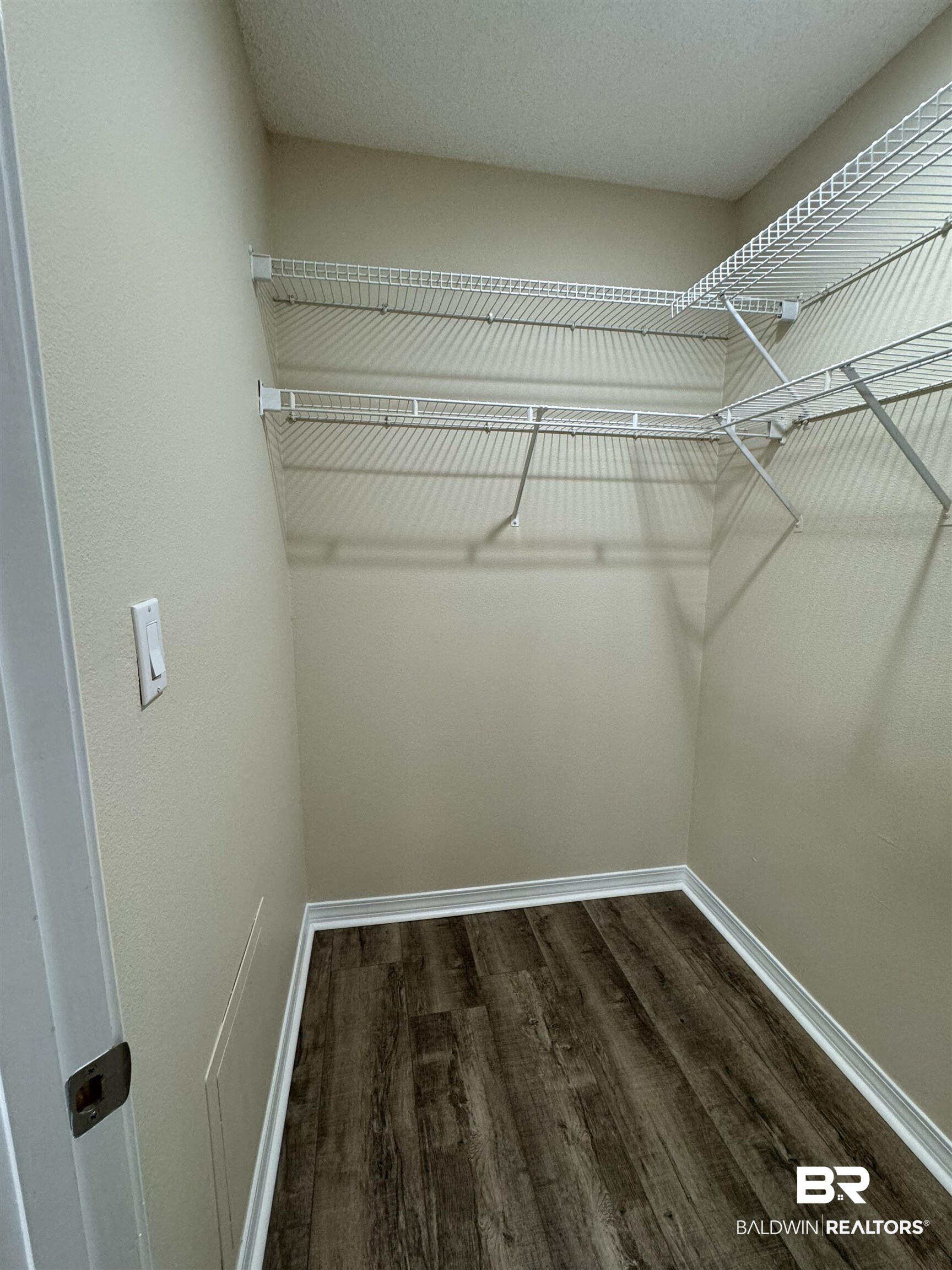 32769 Arbor Ridge Circle Lillian, AL 36549 - Photo 16 of 36 Walk in closet featuring dark hardwood / wood-style floors