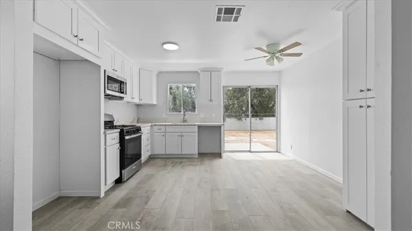 a kitchen with a stove a sink and a refrigerator
