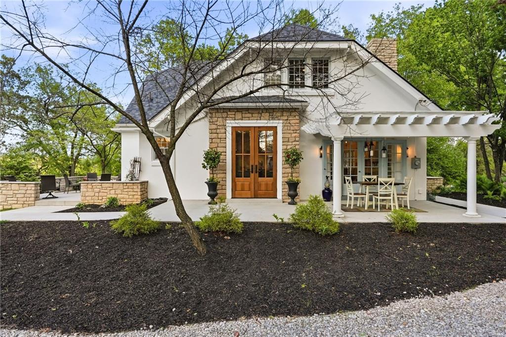 3944 Bakerstown Road Gibsonia, PA 15044 - Photo 11 of 50 a view of a white house next to a yard with potted plants and large trees