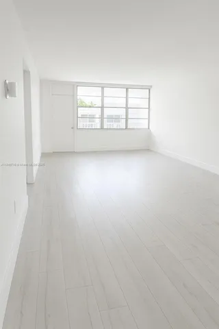 a bathroom with a white bath tub a toilet and a sink