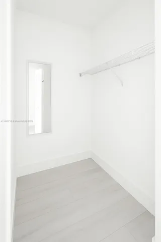 a entryway with a potted plant in front of it