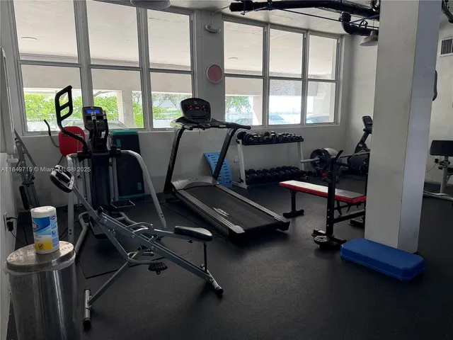 a view of roof deck with dining table and chairs with wooden floor