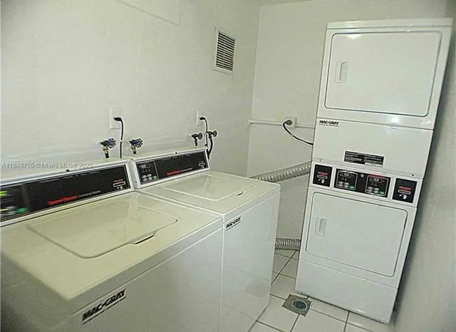 a kitchen with stainless steel appliances white cabinets and a refrigerator