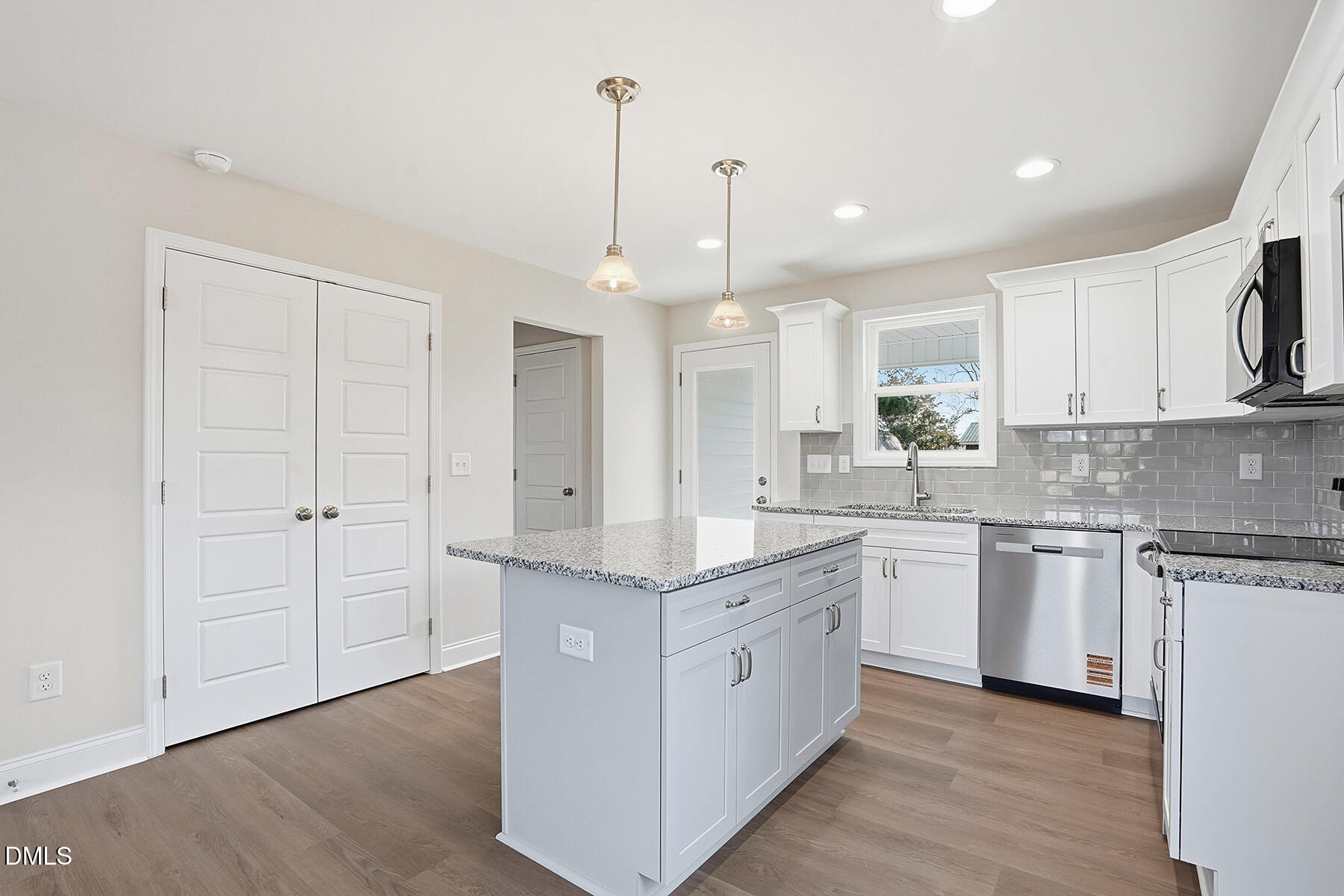 214 Rae Street Warsaw, NC 28398 - Photo 11 of 28 a kitchen with stainless steel appliances granite countertop a sink a stove and a refrigerator