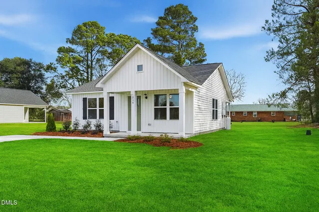 a front view of house with a garden and patio