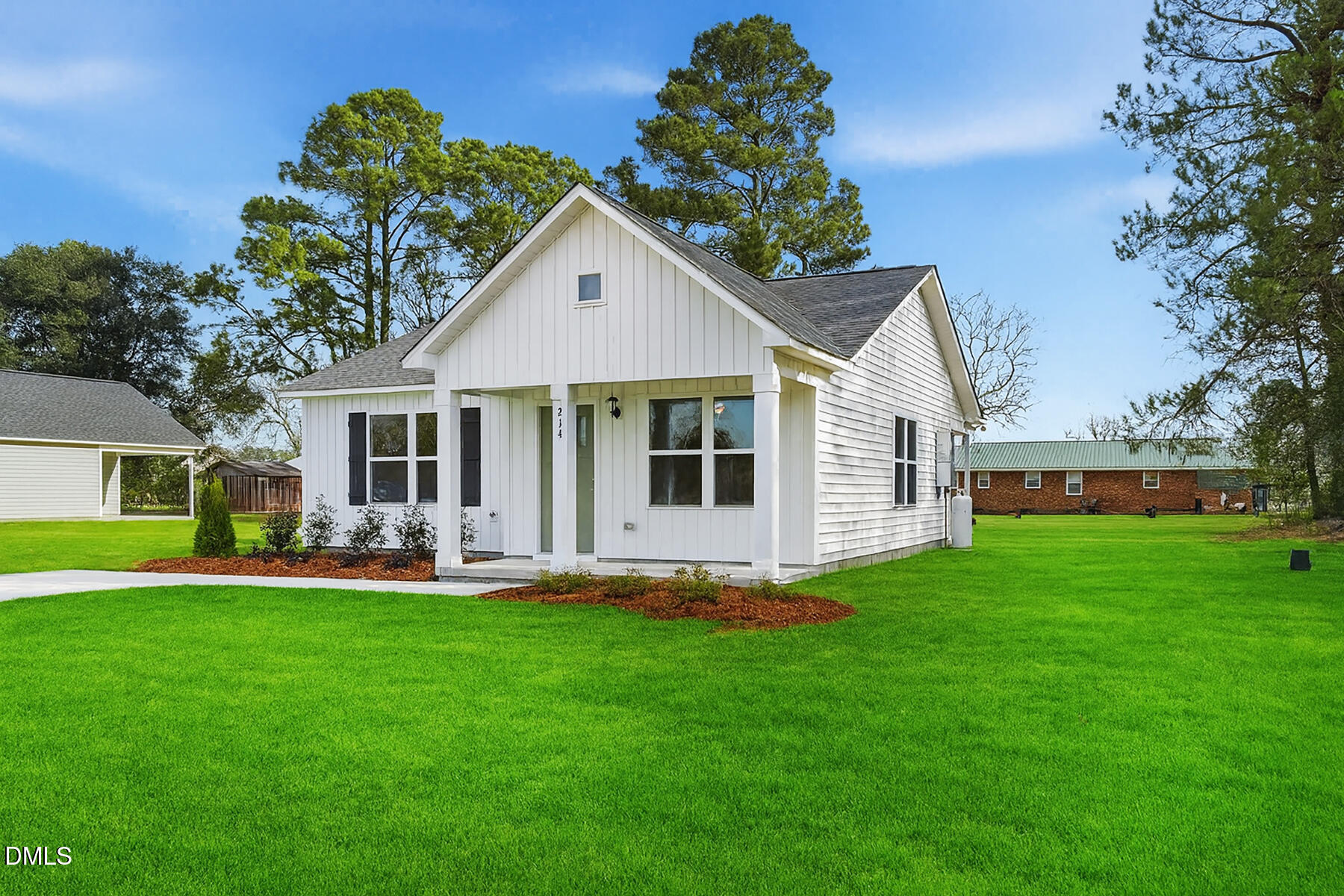 214 Rae Street Warsaw, NC 28398 - Photo 3 of 28 a front view of house with a garden and patio