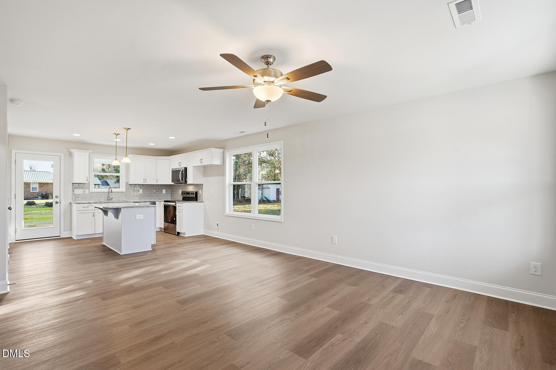 214 Rae Street Warsaw, NC 28398 - Photo 5 of 28 a living room with couches and kitchen view with wooden floor