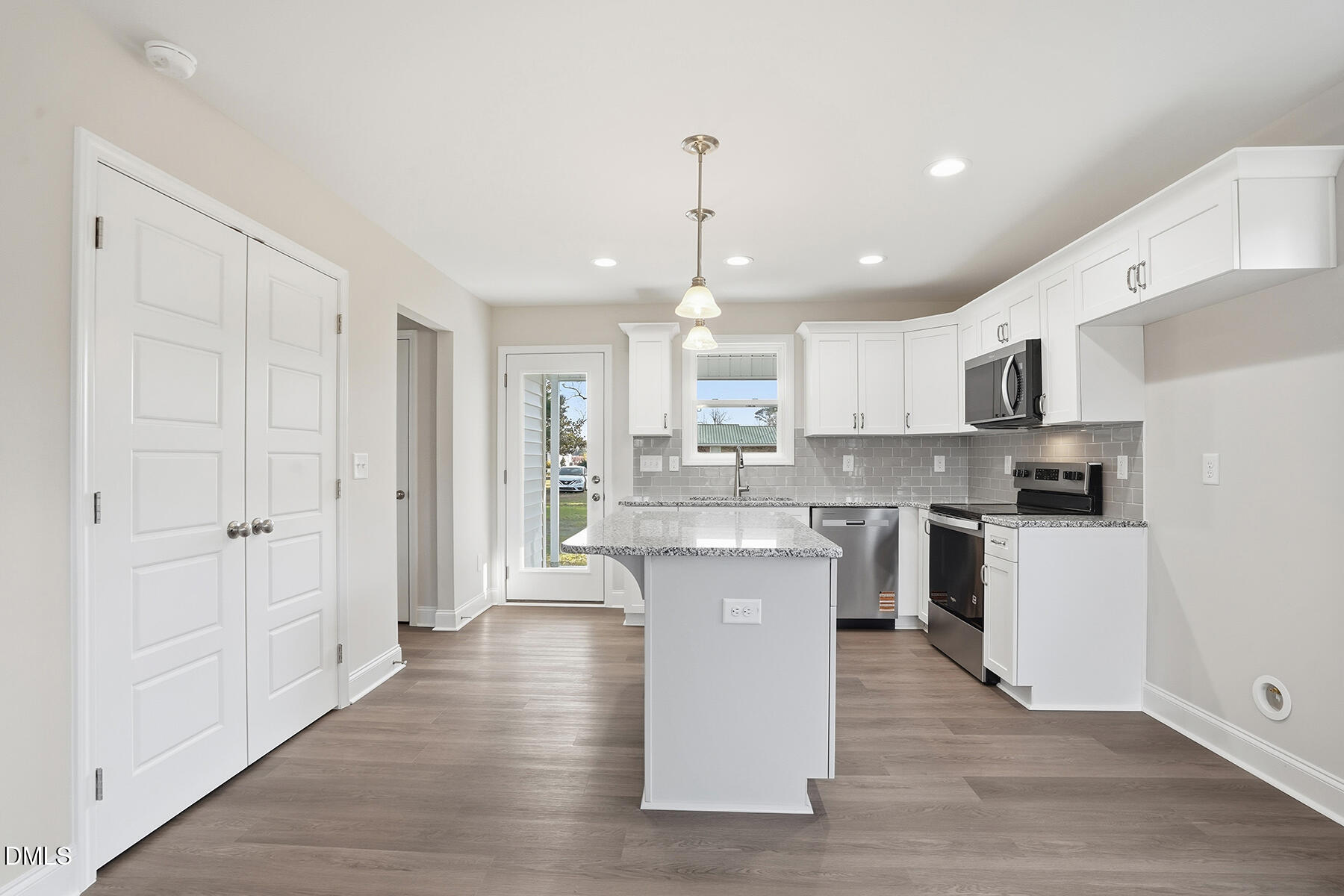 214 Rae Street Warsaw, NC 28398 - Photo 10 of 28 a kitchen with kitchen island white cabinets and stainless steel appliances