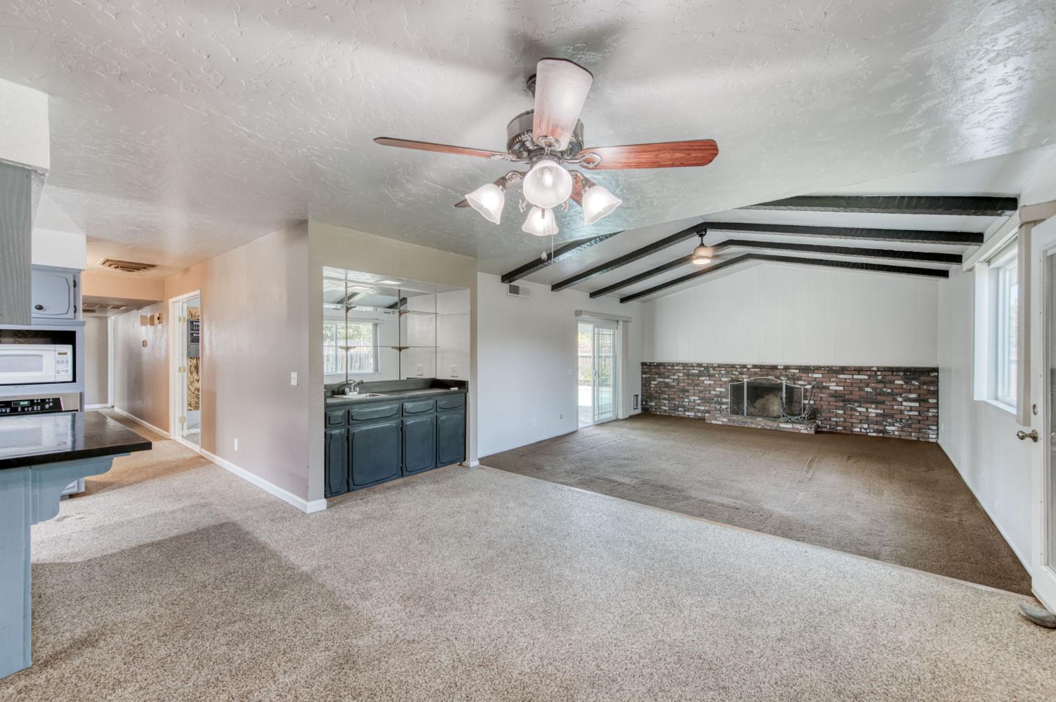 1580 Armstrong Avenue Clovis, CA 93611 - Photo 11 of 50 a view of a hallway with a kitchen and a chandelier