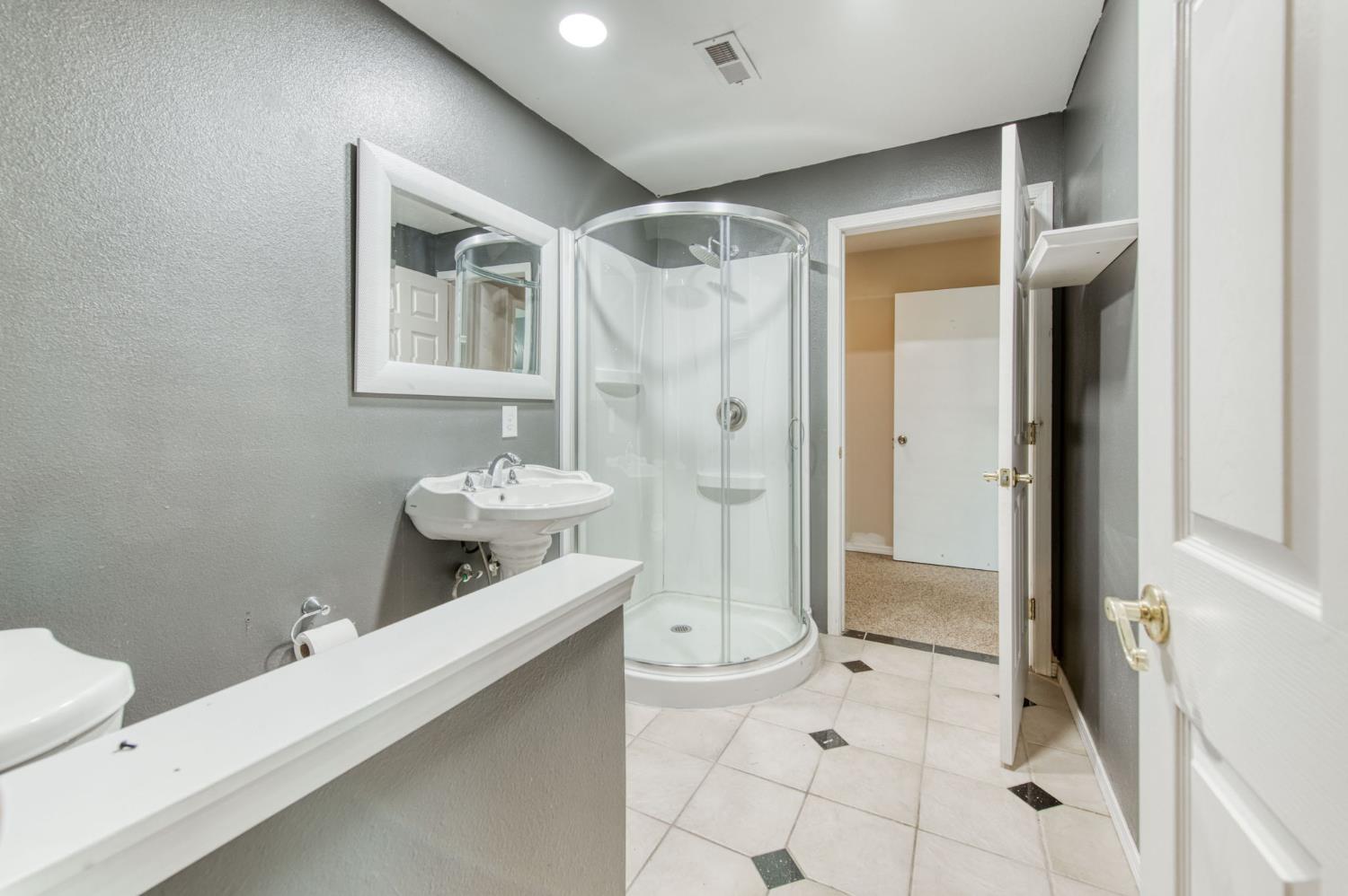 1580 Armstrong Avenue Clovis, CA 93611 - Photo 17 of 50 a bathroom with a double vanity sink mirror and shower