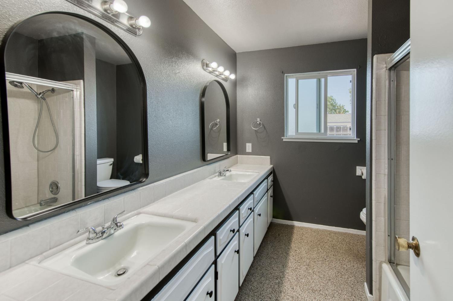 1580 Armstrong Avenue Clovis, CA 93611 - Photo 24 of 50 a bathroom with a double vanity sink and a mirror