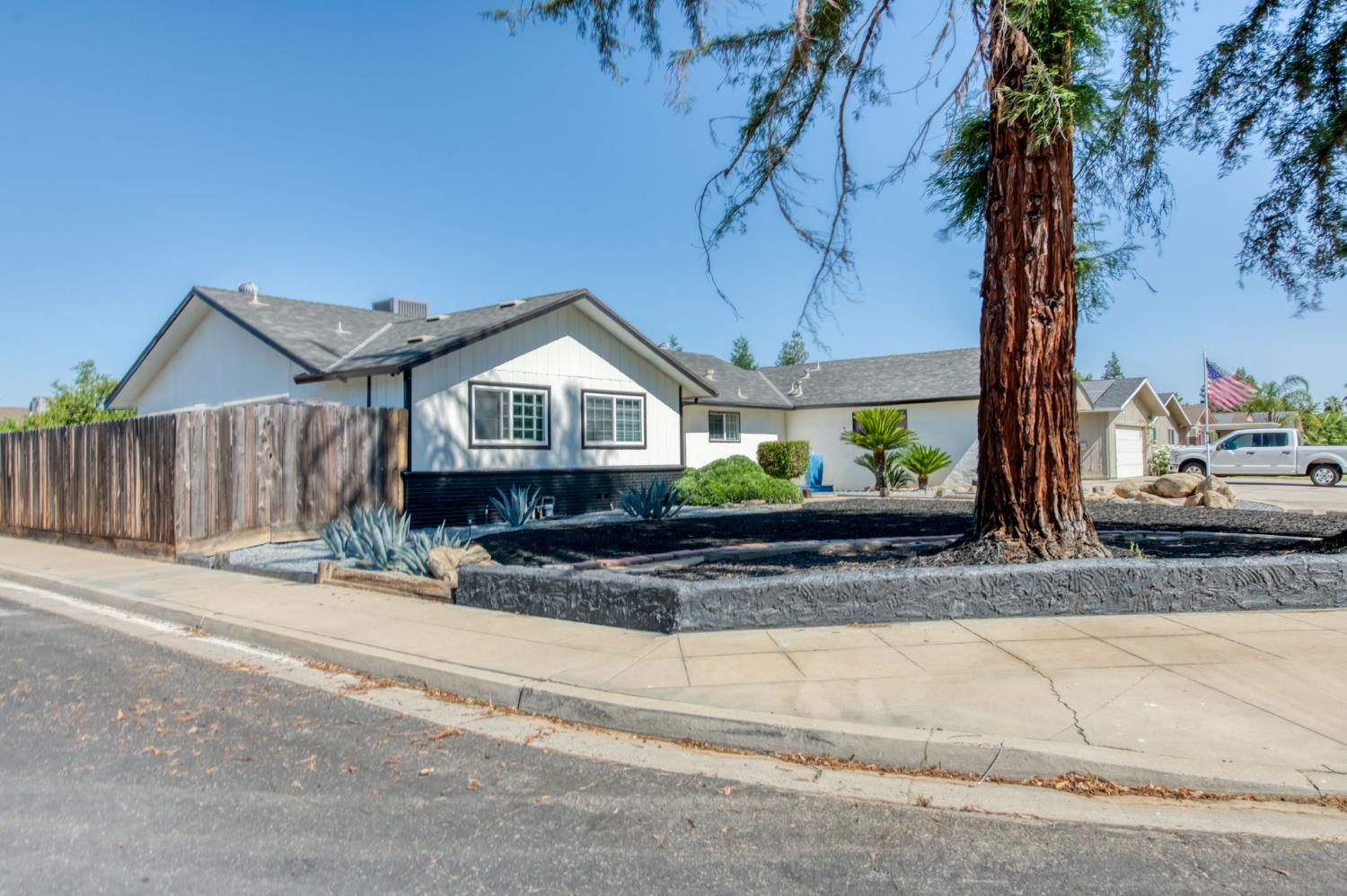 1580 Armstrong Avenue Clovis, CA 93611 - Photo 42 of 50 a front view of a house with a yard and potted plants