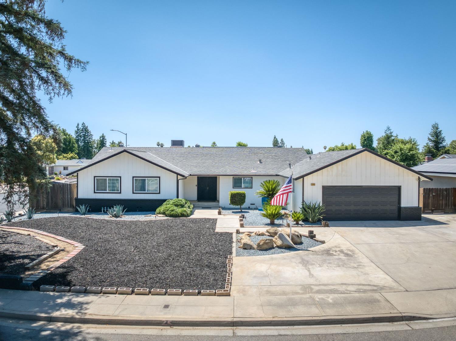 1580 Armstrong Avenue Clovis, CA 93611 - Photo 50 of 50 a front view of a house with a yard and potted plants