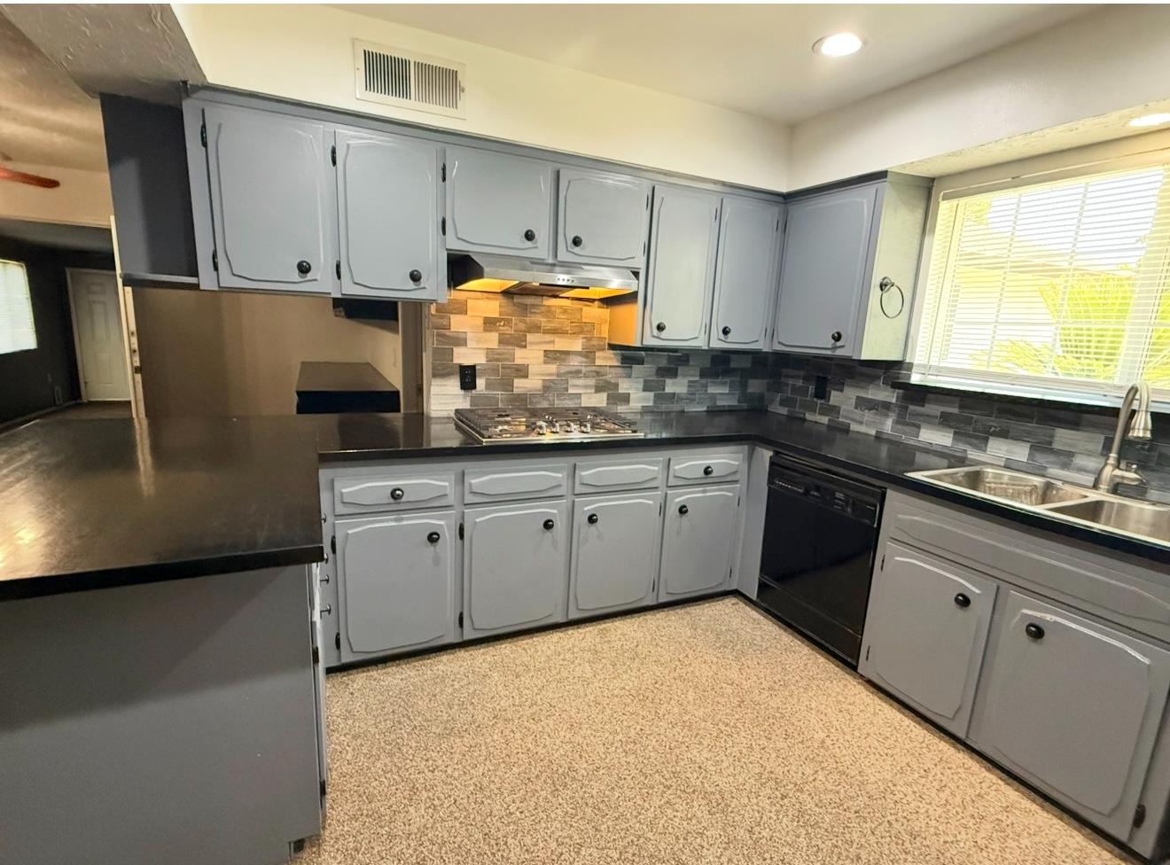 1580 Armstrong Avenue Clovis, CA 93611 - Photo 7 of 50 a kitchen with granite countertop a sink a stove and cabinets