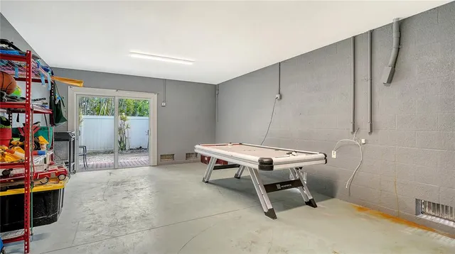 a view of a chair and tables in patio of a house