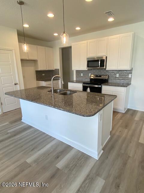 2913 Fleur Lane Jacksonville, FL 32205 - Photo 3 of 3 a large kitchen with stainless steel appliances granite countertop a sink a stove and a wooden floors