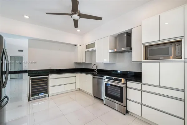 a kitchen with stainless steel appliances granite countertop a stove and cabinets