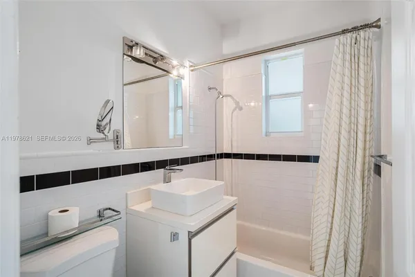 a bathroom with a shower and a sink