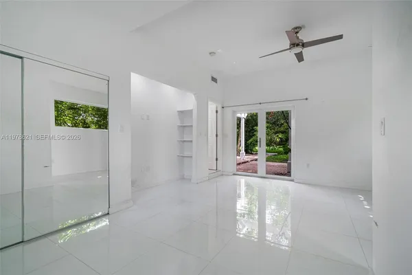 a view of a livingroom with a ceiling fan and window