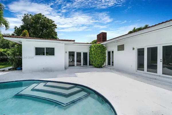 a view of backyard with a patio