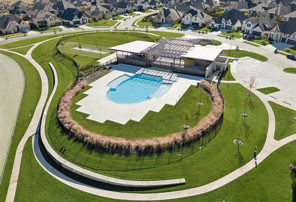 566 Broadleaf Way Haslet, TX 76052 - Photo 35 of 38 Community amenities include a swimming pool with surrounding patio, a modern open-air pavilion, and extensive green spaces with paved pathways