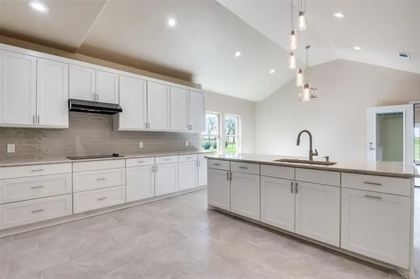 a kitchen with sink and cabinets