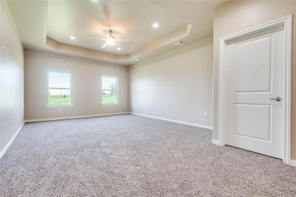 an empty room with windows and closet