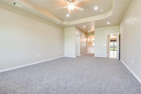 a view of an empty room and a ceiling fan