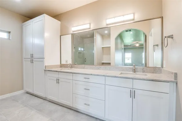 a bathroom with a granite countertop sink mirror and