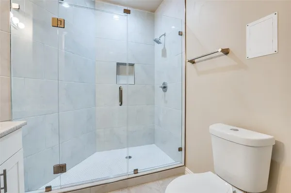 a bathroom with a shower and toilet