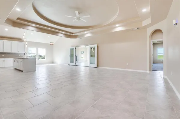 a view of a hallway with a room and kitchen view